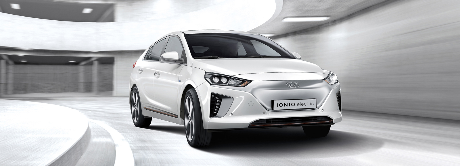 Side front view of white Ioniq Electric parked outside